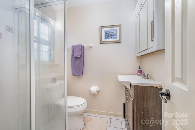 bathroom featuring tile patterned floors, toilet, vanity, a shower stall, and baseboards