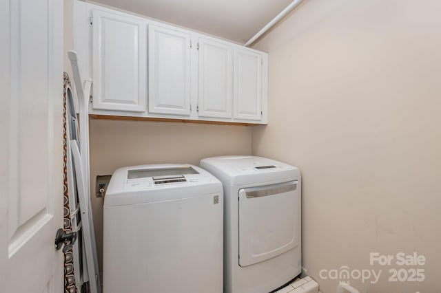 laundry area with cabinet space and independent washer and dryer