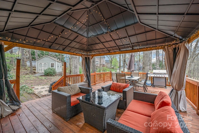 wooden deck featuring a gazebo, grilling area, an outdoor living space, an outdoor structure, and a shed