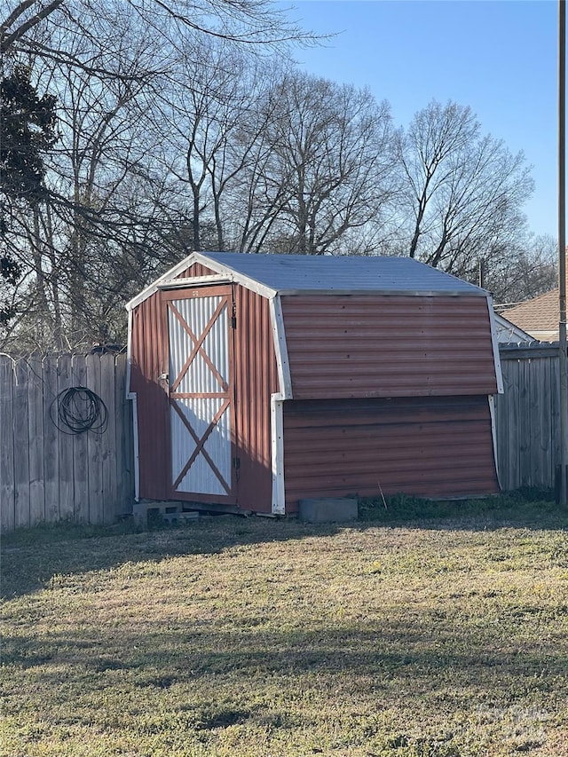 view of shed featuring fence