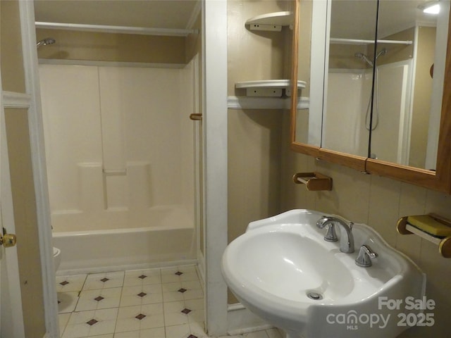 full bath with tile patterned flooring and a sink