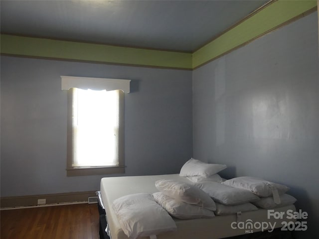 bedroom featuring wood finished floors