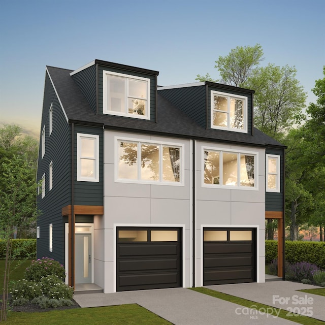 contemporary house with a garage, driveway, and stucco siding