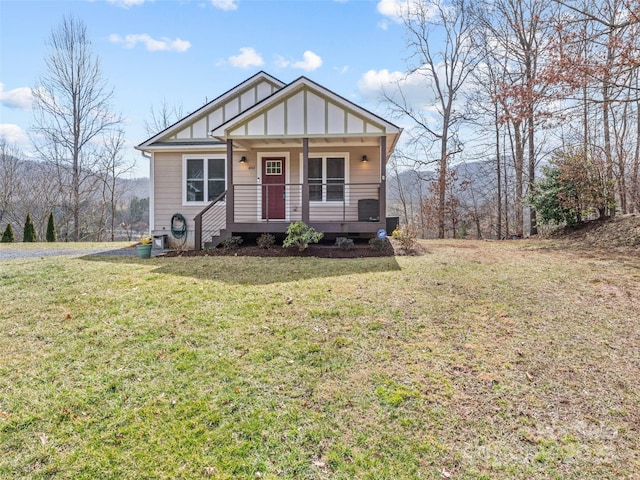 view of front of house featuring a porch, a front yard, and board and batten siding