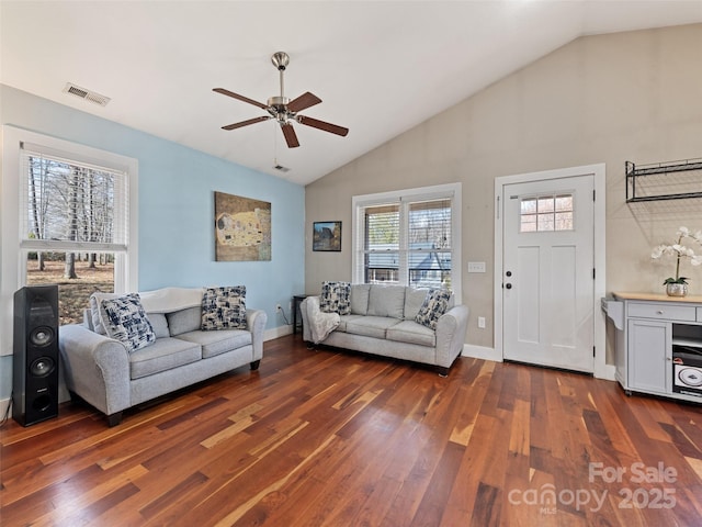 living area with a ceiling fan, baseboards, visible vents, and wood finished floors