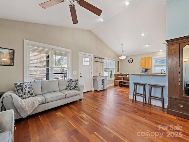 living area with lofted ceiling, ceiling fan, dark wood-style flooring, and recessed lighting