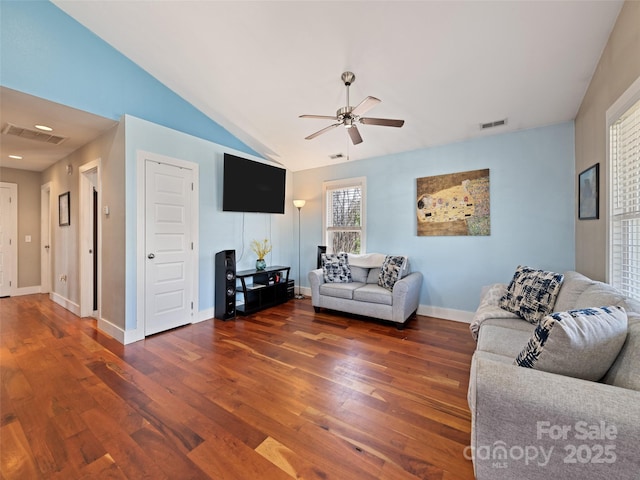 living area featuring a ceiling fan, lofted ceiling, visible vents, and wood finished floors