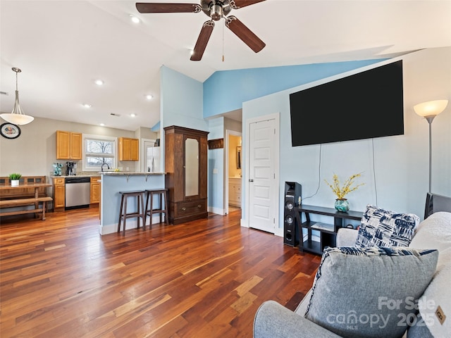 living area with lofted ceiling, wood finished floors, a ceiling fan, and recessed lighting