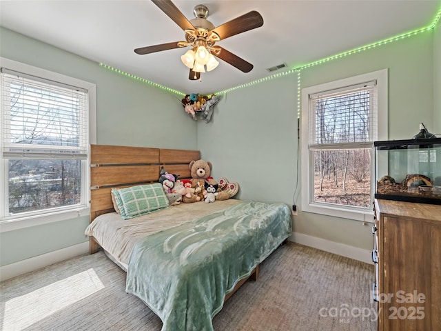 bedroom featuring baseboards, visible vents, and ceiling fan