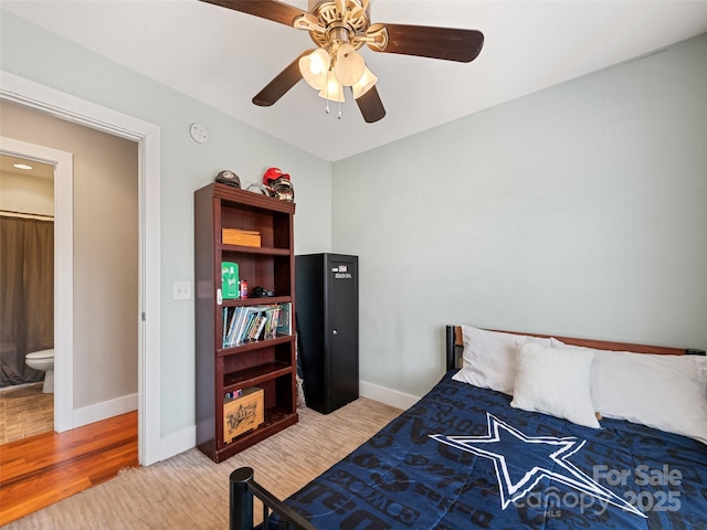 bedroom with ceiling fan, light wood-type flooring, and baseboards