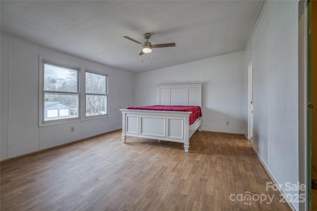 unfurnished bedroom with ceiling fan and wood finished floors