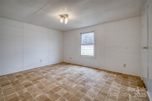 spare room with a textured ceiling