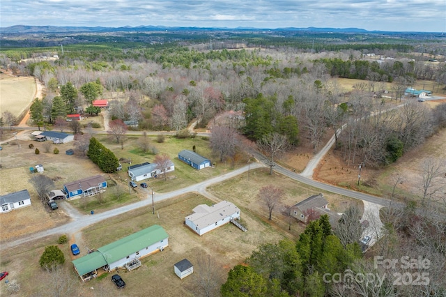 birds eye view of property featuring a mountain view and a rural view