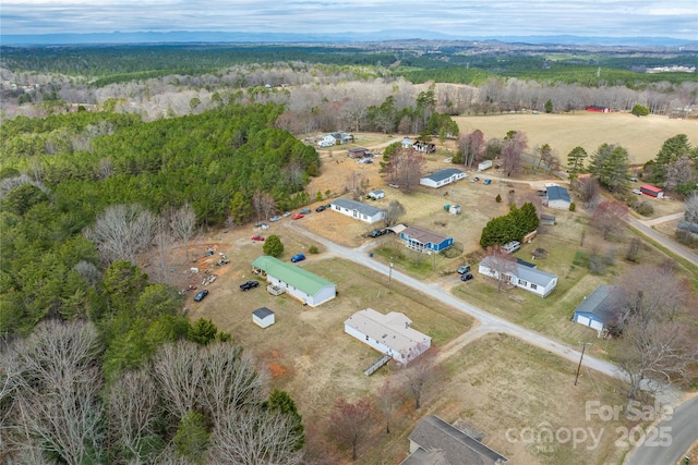 birds eye view of property with a wooded view