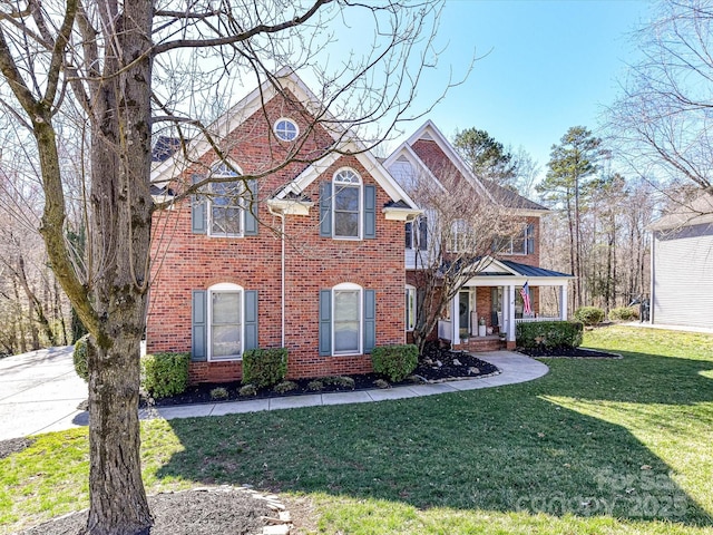 view of front of home with brick siding and a front yard