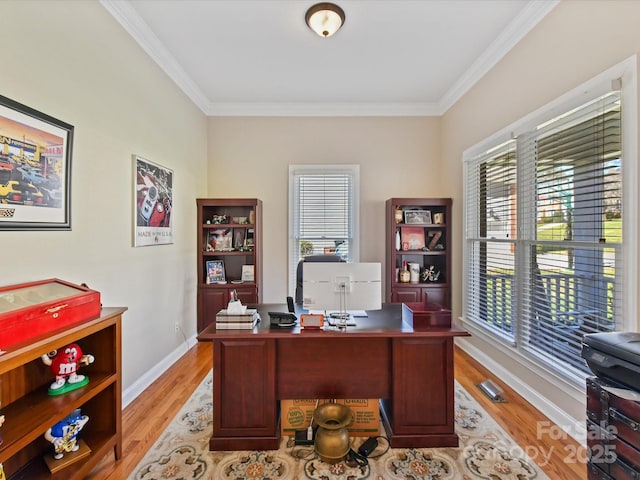 home office featuring light wood-type flooring, baseboards, and ornamental molding