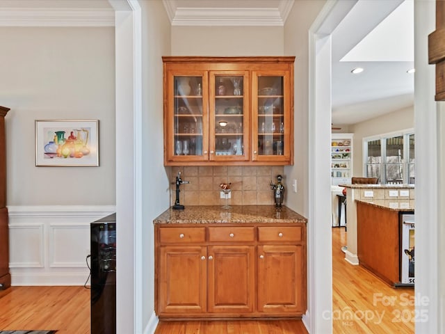 bar with wine cooler, recessed lighting, light wood-type flooring, decorative backsplash, and crown molding