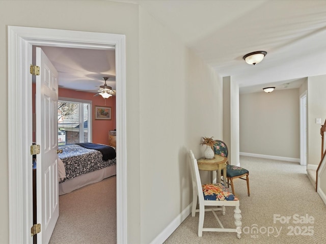 hallway with carpet and baseboards