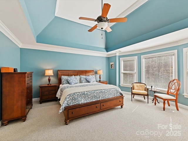 carpeted bedroom featuring ceiling fan, baseboards, a raised ceiling, and ornamental molding