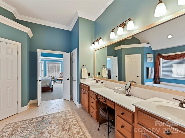 ensuite bathroom with a healthy amount of sunlight, connected bathroom, a sink, and tile patterned floors