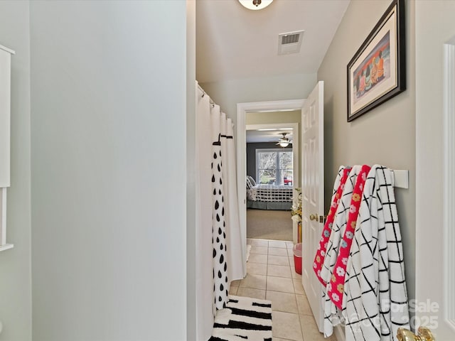 hallway with light tile patterned floors and visible vents