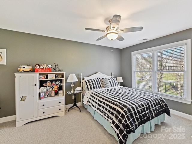 bedroom with baseboards, visible vents, ceiling fan, and carpet flooring