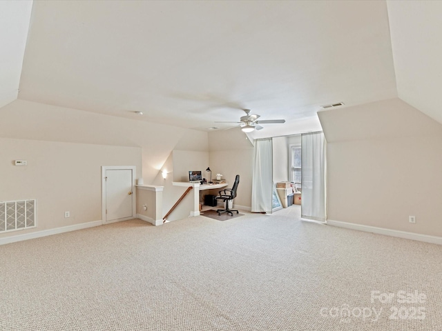 bonus room featuring light colored carpet, visible vents, lofted ceiling, and baseboards