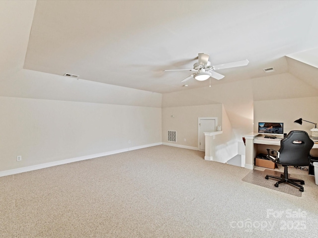 office area featuring carpet, visible vents, and vaulted ceiling