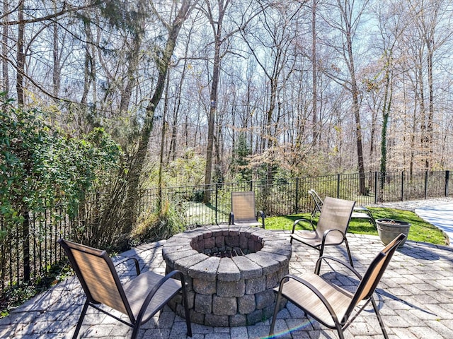 view of patio / terrace featuring fence and a fire pit