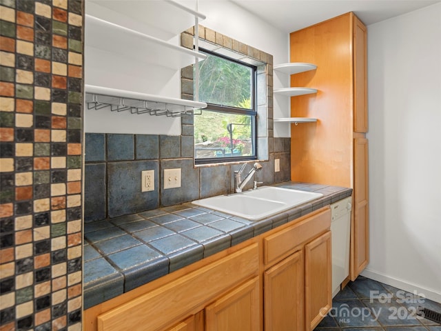 kitchen featuring decorative backsplash, dishwasher, tile countertops, open shelves, and a sink