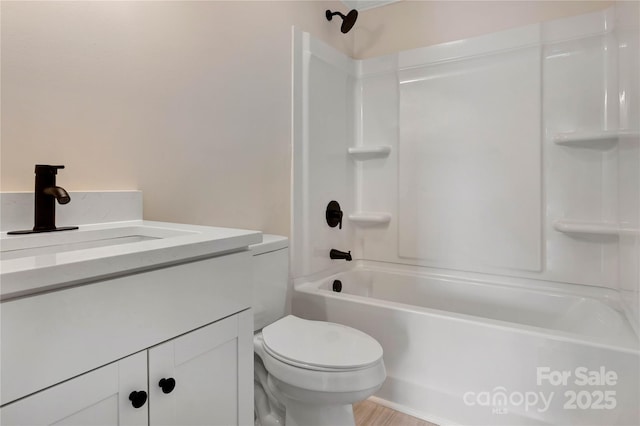 bathroom featuring bathtub / shower combination, vanity, and toilet