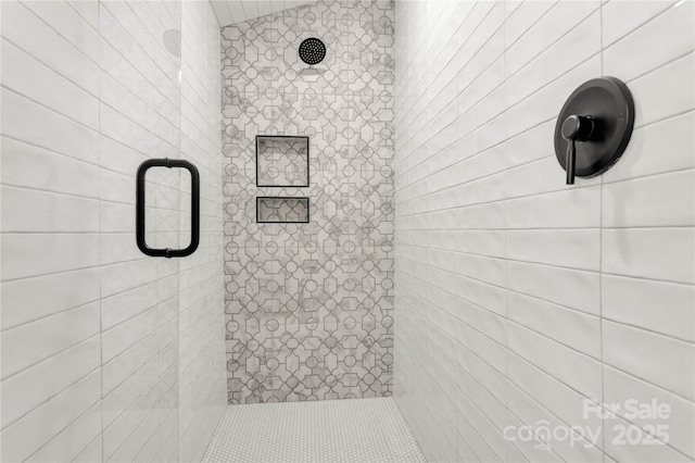 full bath featuring a tile shower