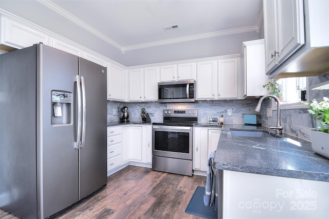 kitchen with a sink, ornamental molding, visible vents, and stainless steel appliances