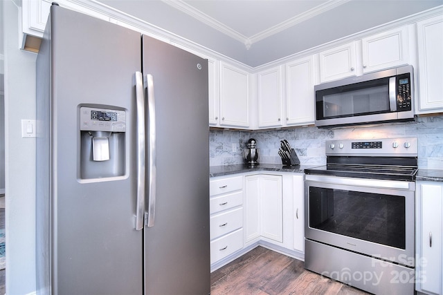 kitchen with backsplash, crown molding, dark wood finished floors, appliances with stainless steel finishes, and white cabinets