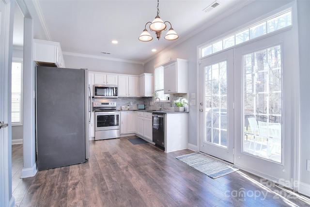 kitchen with backsplash, appliances with stainless steel finishes, dark wood-style floors, and crown molding