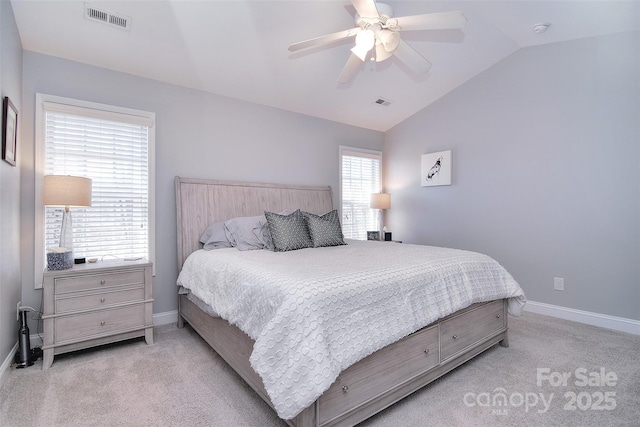 bedroom with vaulted ceiling, baseboards, visible vents, and light carpet