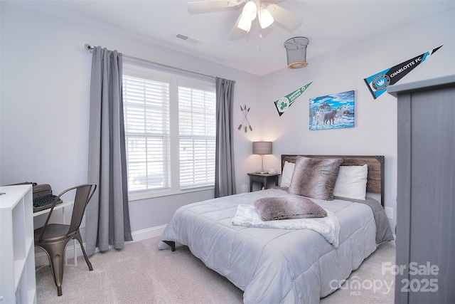 bedroom featuring ceiling fan, baseboards, visible vents, and light carpet