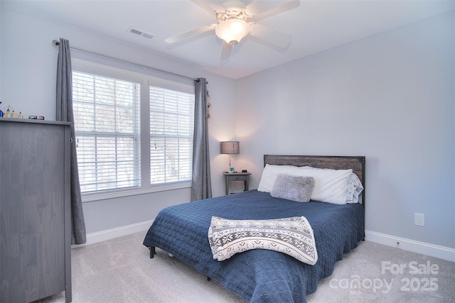 bedroom with visible vents, baseboards, carpet, and a ceiling fan