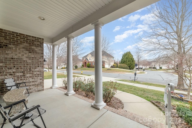 view of patio / terrace featuring a porch and a residential view