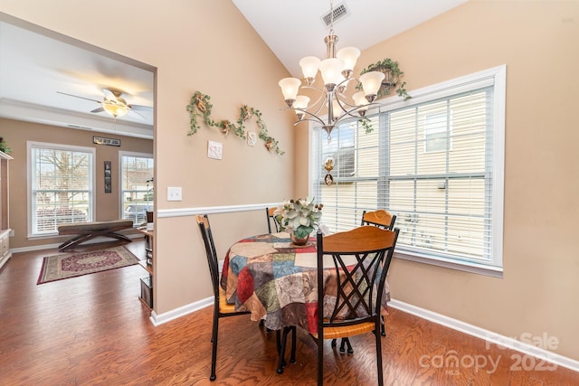 dining space featuring lofted ceiling, wood finished floors, visible vents, and baseboards