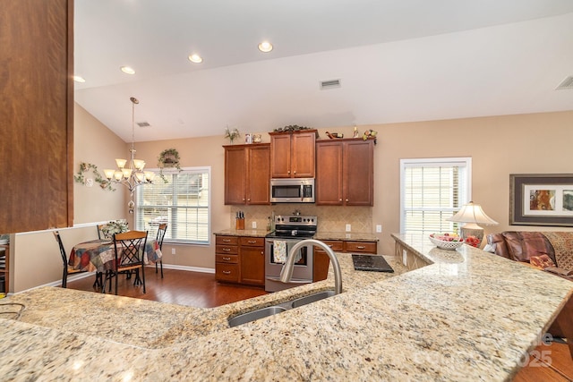 kitchen featuring stainless steel appliances, dark wood-style flooring, a sink, visible vents, and vaulted ceiling