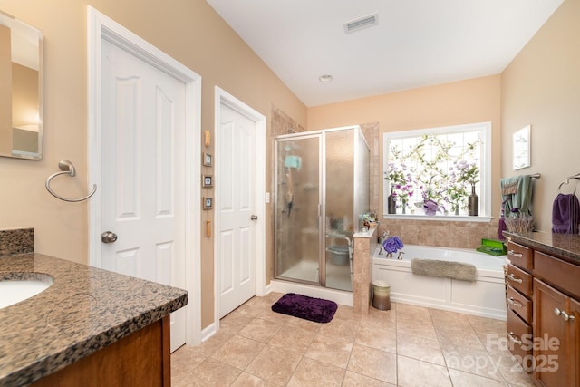 full bathroom featuring visible vents, a garden tub, tile patterned flooring, vanity, and a shower stall