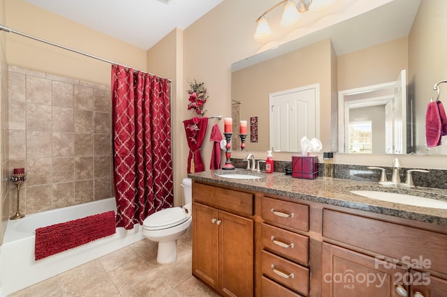 full bath with tile patterned flooring, a sink, toilet, and double vanity