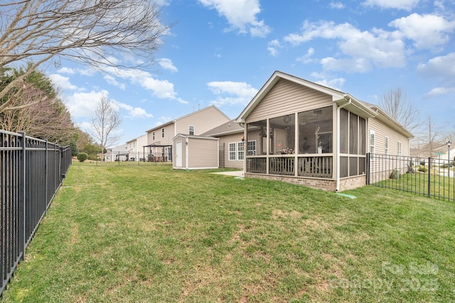 view of yard featuring an outbuilding, a sunroom, a fenced backyard, and a storage unit