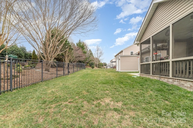 view of yard featuring a sunroom and fence