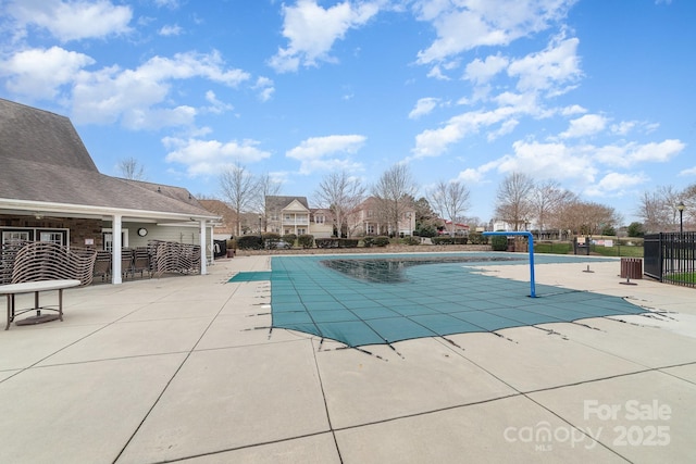 pool featuring a patio area and fence