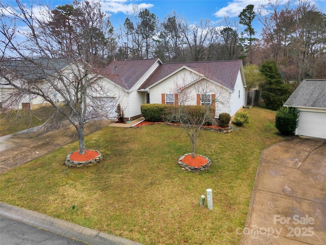 ranch-style home with driveway, an attached garage, roof with shingles, and a front lawn