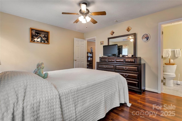 bedroom with baseboards, a ceiling fan, dark wood finished floors, and ensuite bathroom