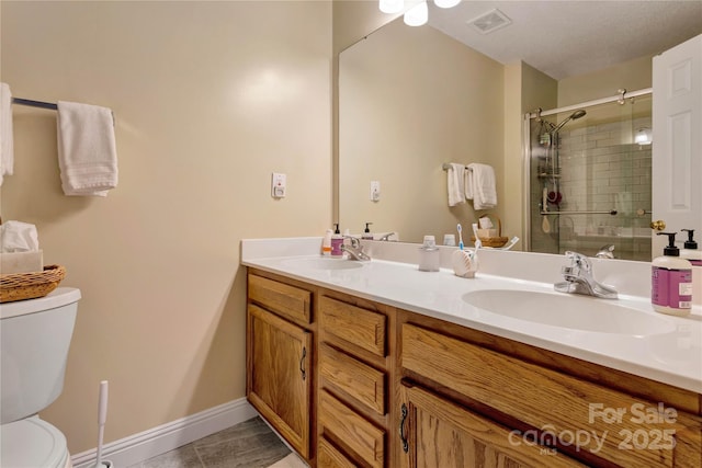 bathroom with a shower stall, toilet, visible vents, and a sink