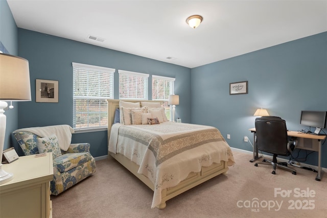 bedroom with baseboards, visible vents, and light colored carpet